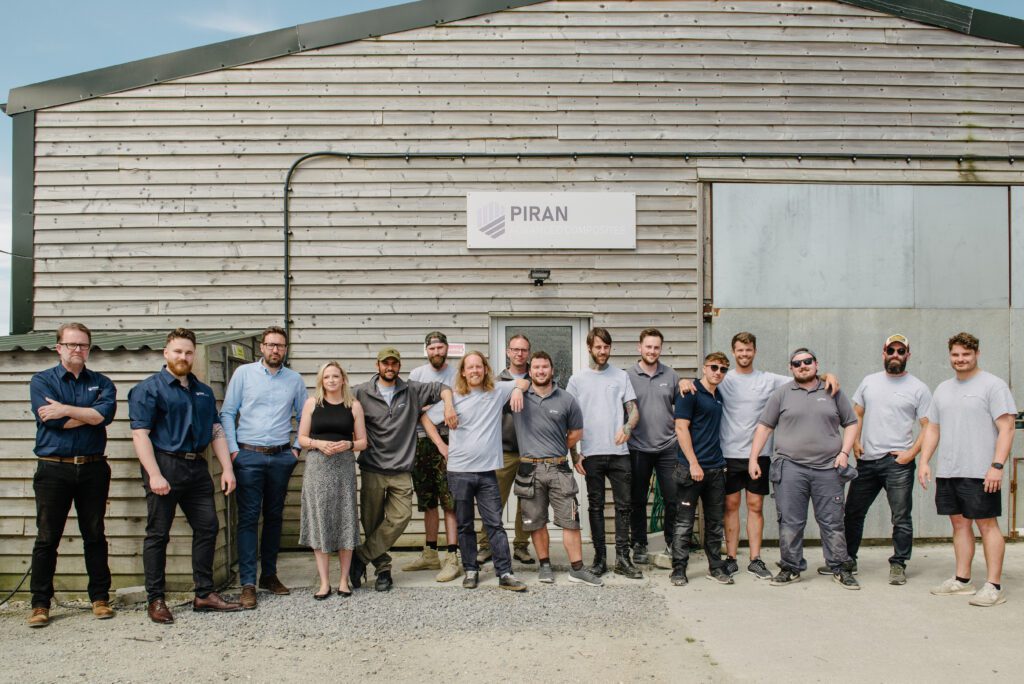 The whole Piran composite steam outside their workshop