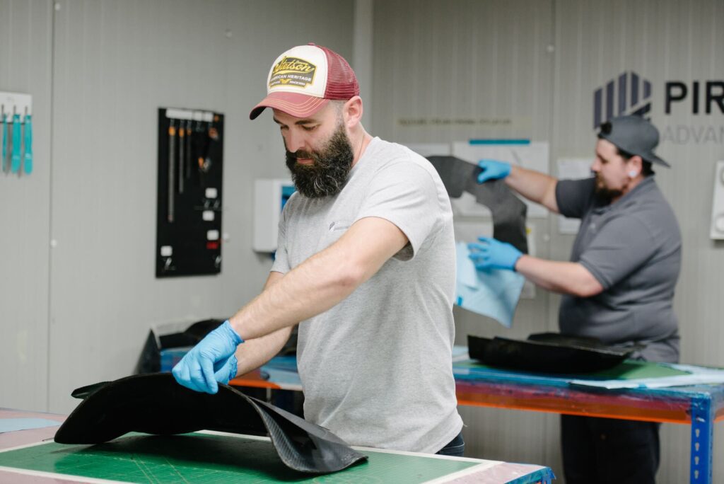 two men working by hand on composite materials