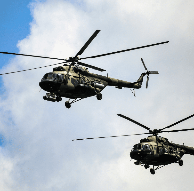 two defence helicopters mid air