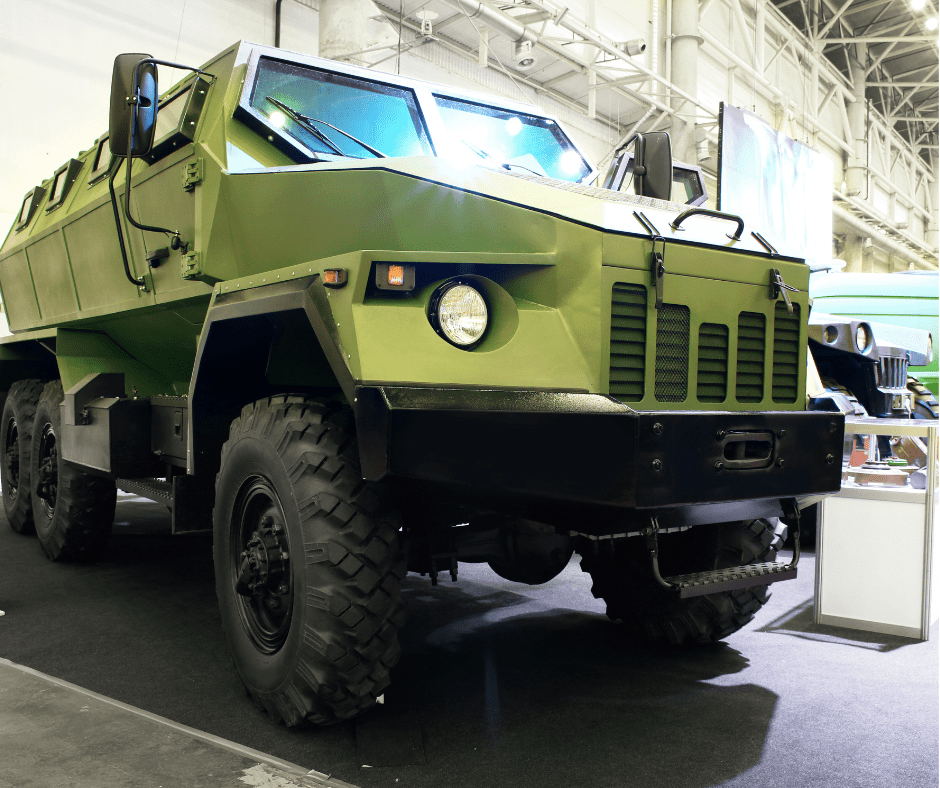 close up of green military truck inside building 