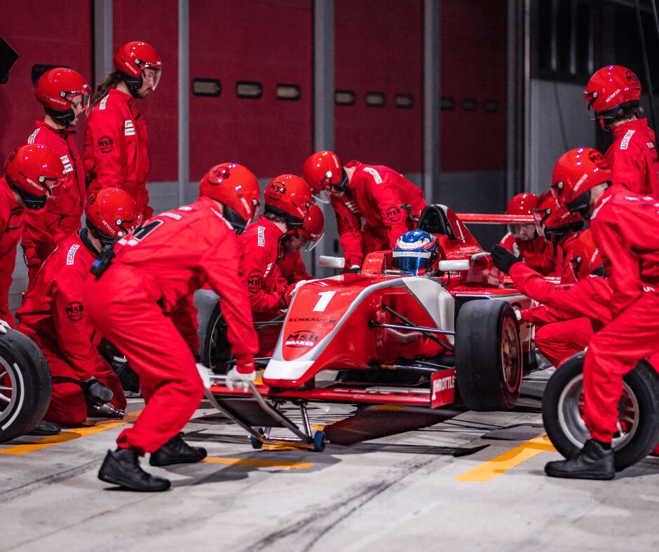 f1 car team changing wheels 